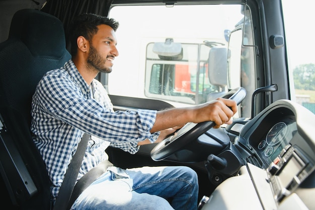 Happy professional truck driver driving his truck Copy space