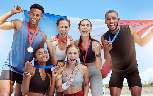 Photo happy and proud french olympic athletes celebrating winning medals for their country portrait of a diverse group of sports people with a french flag cheering and proud of their success and victory