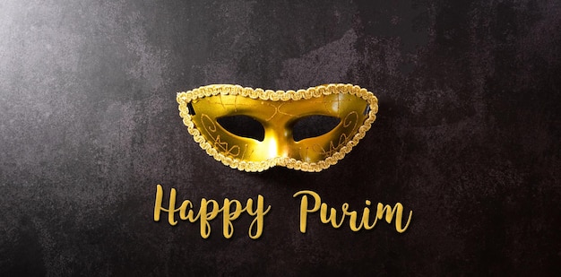 Photo happy purim carnival decoration concept made from golden mask on dark background happy purim in hebrew jewish holiday celebrate