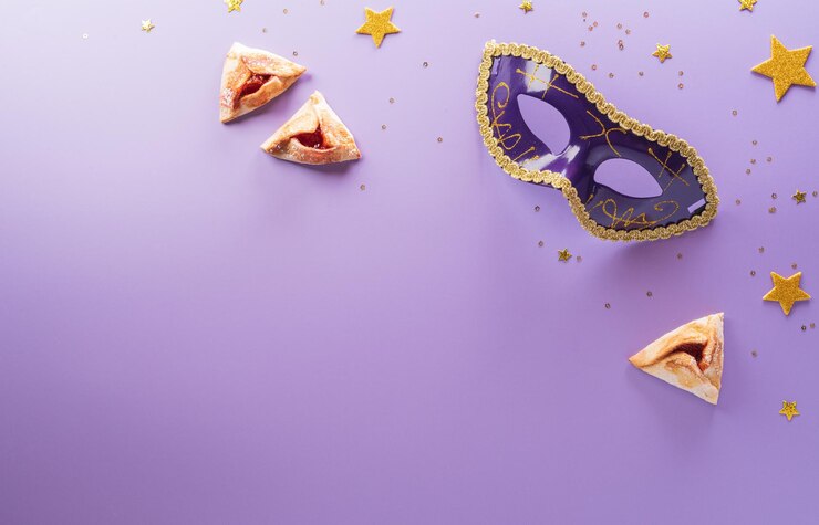 Happy Purim carnival decoration concept made from mask and sparkle star and hamantaschen cookies on pastel background Happy Purim in Hebrew jewish holiday celebrate