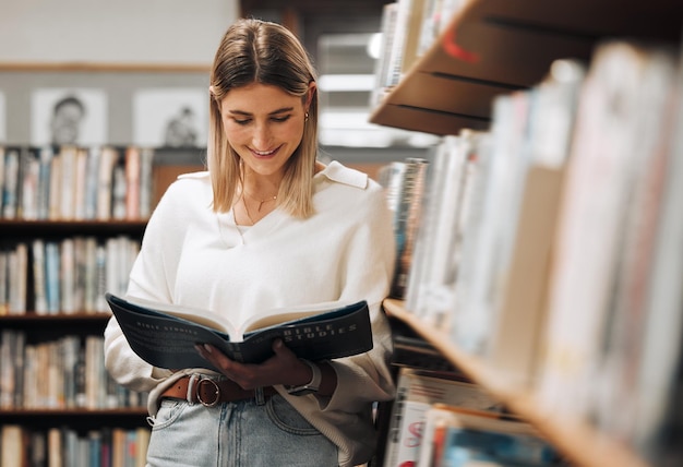 Happy reading or student in library for books educational knowledge or research for learning or assessment School girl college or university student studying for insight or scholarship on campus