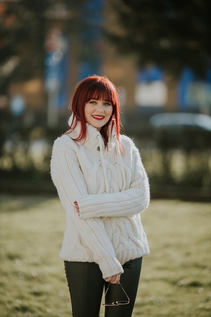 Happy red hair Caucasian female from Bosnia and Herzegovina posing in the park