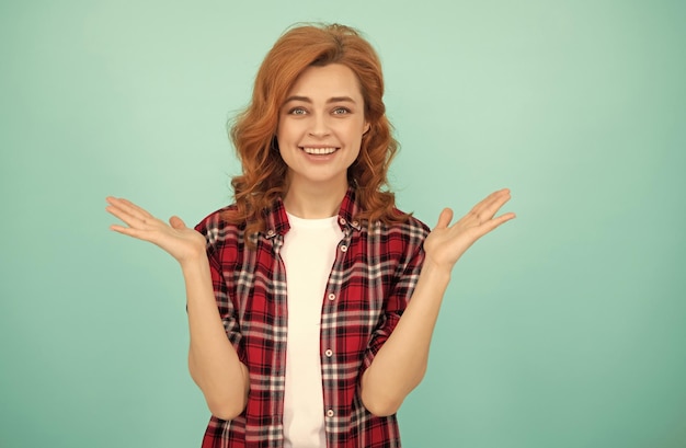 Happy red haired woman redhead woman in checkered shirt express positive emotions