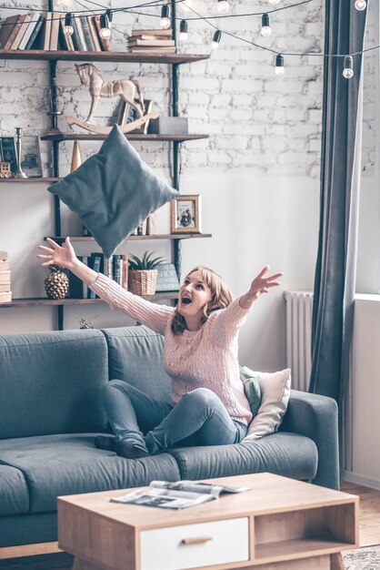 Happy redhair woman with amazing smile laughing in her room. Indoor portrait of emotional woman in the loft fun in morning.