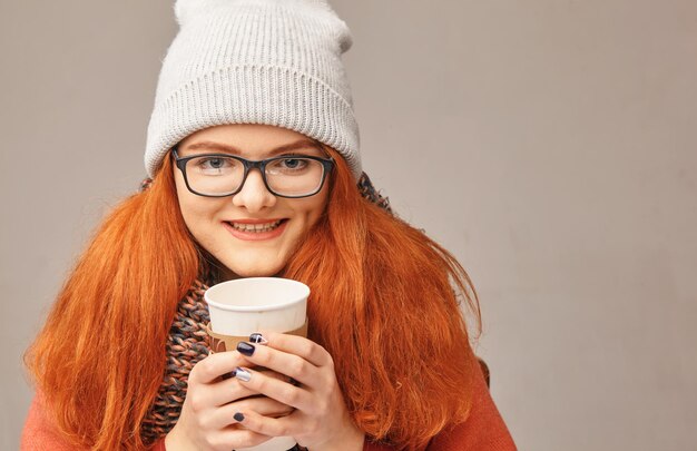 Happy redhaired beauty with a cup of coffee