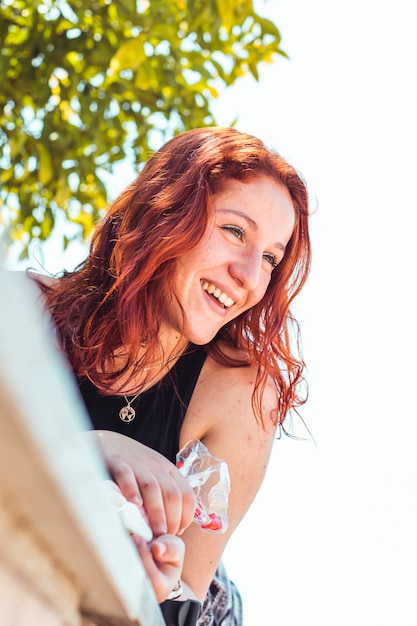 Happy redhead girl in a park