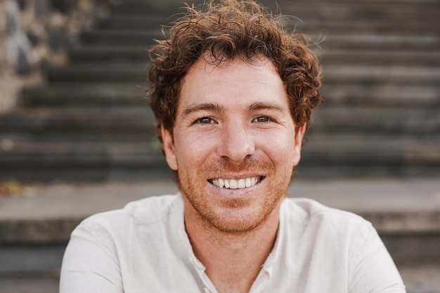 Happy redhead man smiling on camera outdoor