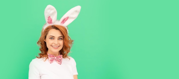 Happy redhead woman in bunny rabbit ears with painted eggs easter Woman isolated face portrait