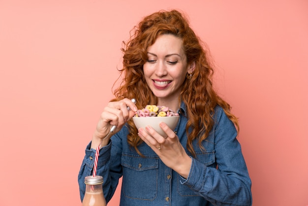 Happy Redhead woman having breakfast