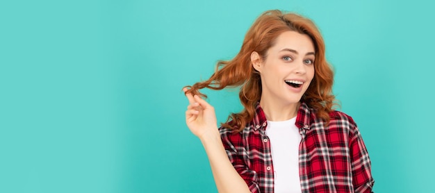 Happy redhead woman with curly hair in checkered casual shirt style Woman isolated face portrait banner with mock up copyspace