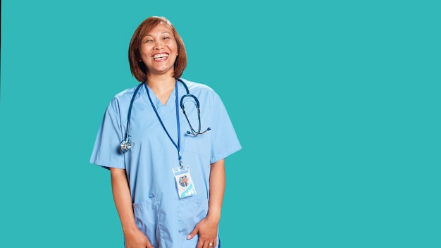 Happy relaxed BIPOC nurse having burst of laughter while at work. Cheerful healthcare specialist enjoying funny chat with clinic coworker during shift break, isolated over studio background