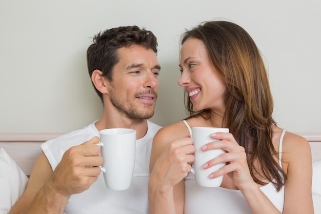 Happy relaxed couple with coffee cups