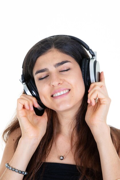 Happy relaxed woman portrait enjoy listen to music closed eyes with earphones