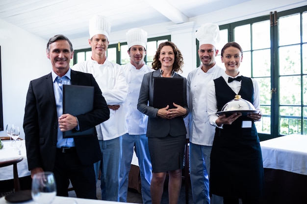 Happy restaurant team standing together in restaurant