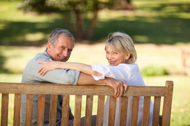 Happy retired couple sitting on the bench