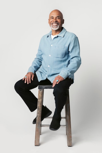 Happy retired man sitting on a stool