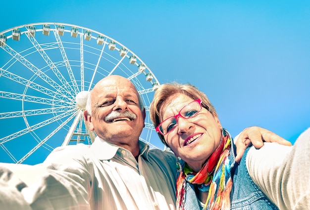 Happy retired senior couple taking selfie at travel around the world