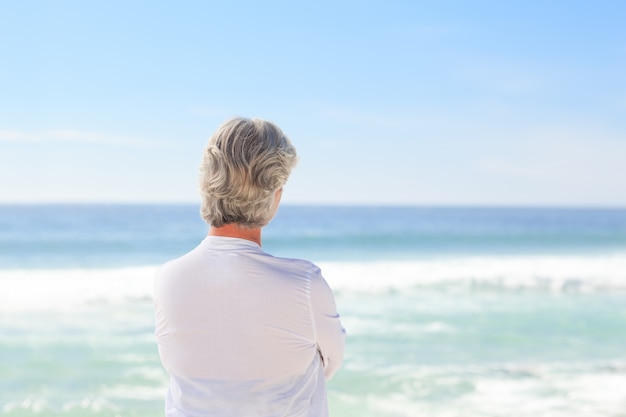 Happy retired woman on the beach