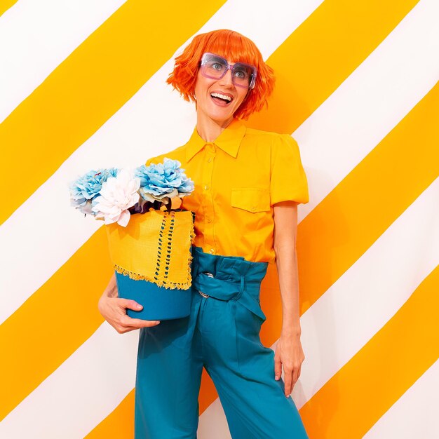 Happy Retro Lady on trend striped yellow background with flower arrangement in her hands