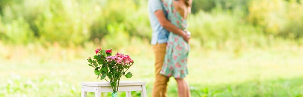 Happy Romantic couple hugging. Focus on flowers. selective focuse.