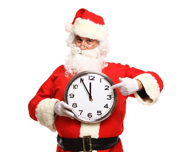 Happy Santa in eyeglasses pointing at clock showing five minutes to Christmas