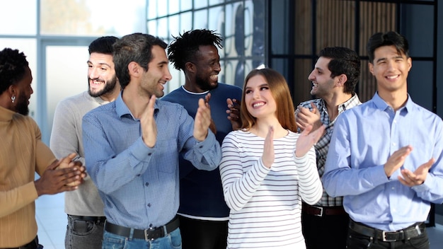 Happy satisfied multiracial business people dressed in casual clothes cheering at camera after attending