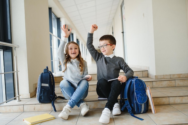 Happy school kids in corridor at school