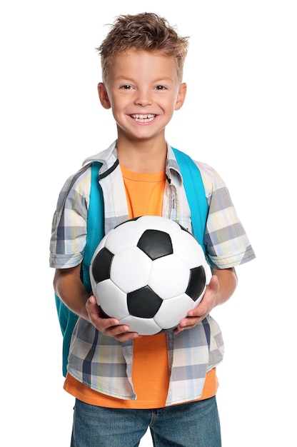 Happy schoolboy with backpack and soccer ball isolated on white background