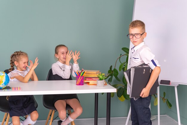 happy schoolchildren boy and girl study at school together