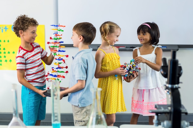 Happy schoolchildren in laboratory