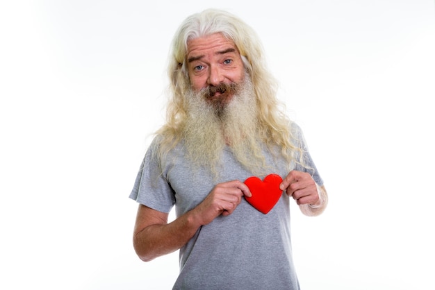 happy senior bearded man smiling and holding red heart