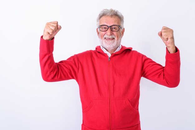 happy senior bearded man smiling while flexing both arms ready for gym on white