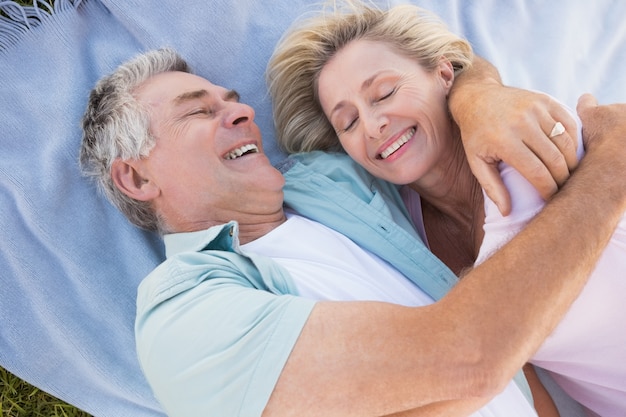 Счастливый старший пара, обниматься на одеяло