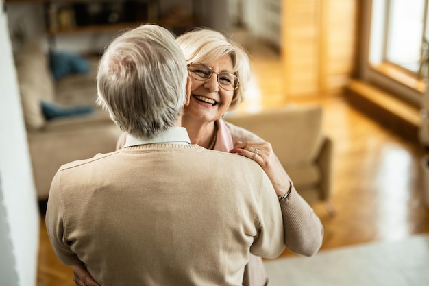 Happy senior couple enjoying while dancing at home