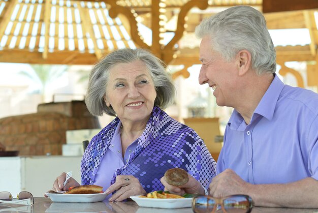 Happy Senior couple having breakfast in cafe