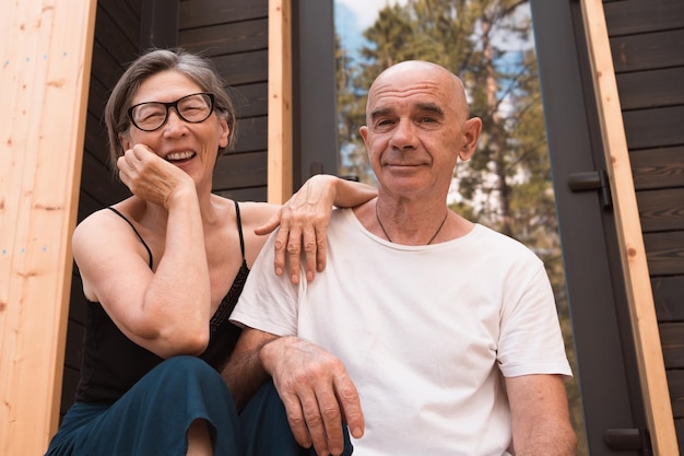 Happy senior couple in love sitting on the terrace at home