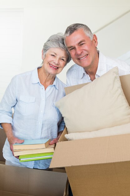 Happy senior couple moving into new home