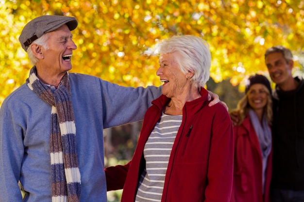 Happy senior couple at park during autumn