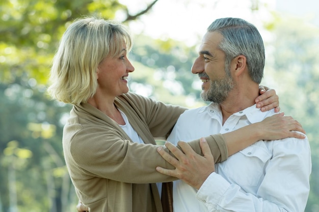 Happy senior couple in park in love and romantic