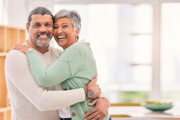 Happy senior couple portrait and hug with love in living room bonding romance or embrace together at home Mature man or woman smile in happiness for loving relationship affection or quality time