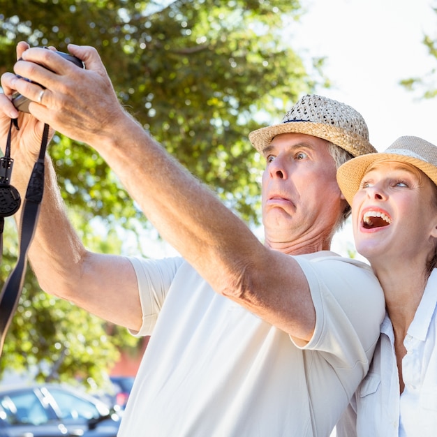 Happy senior couple posing for a selfie