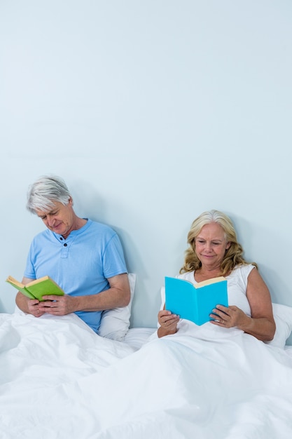 Happy senior couple reading book