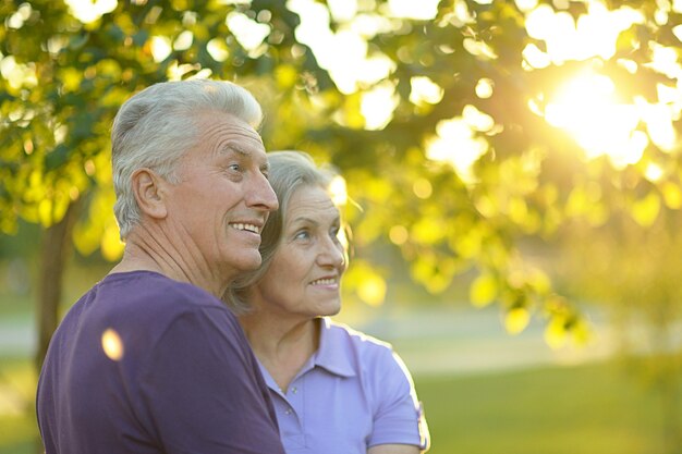 Happy senior couple relaxing in autumn park