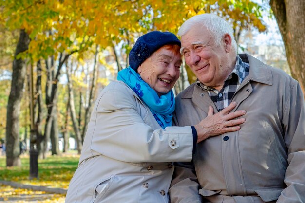 Happy senior couple relaxing in autumn park