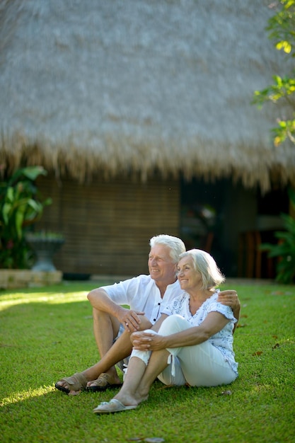 Happy Senior couple sitting on grass