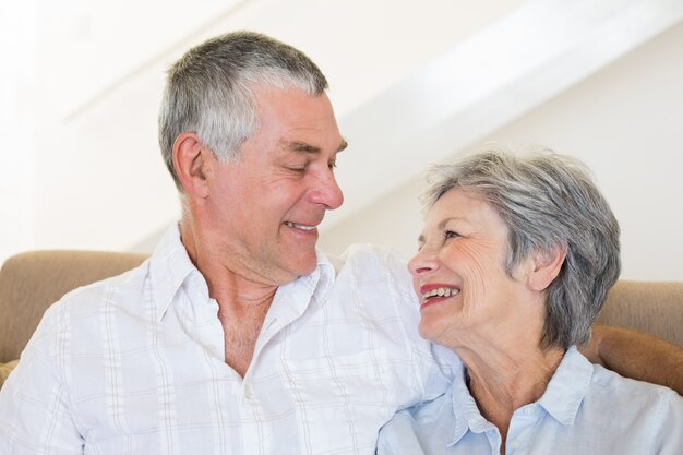 Happy senior couple sitting on sofa