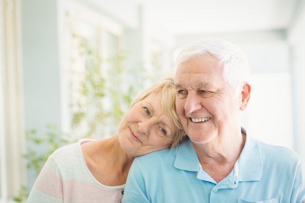 Happy senior couple smiling at home