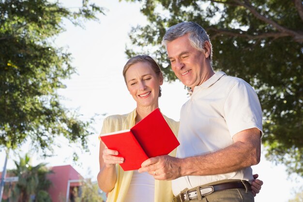 Happy senior couple using the guidebook 