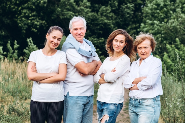 Happy senior couple with their daughters in nature