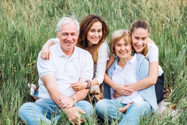 Happy senior couple with their daughters in nature